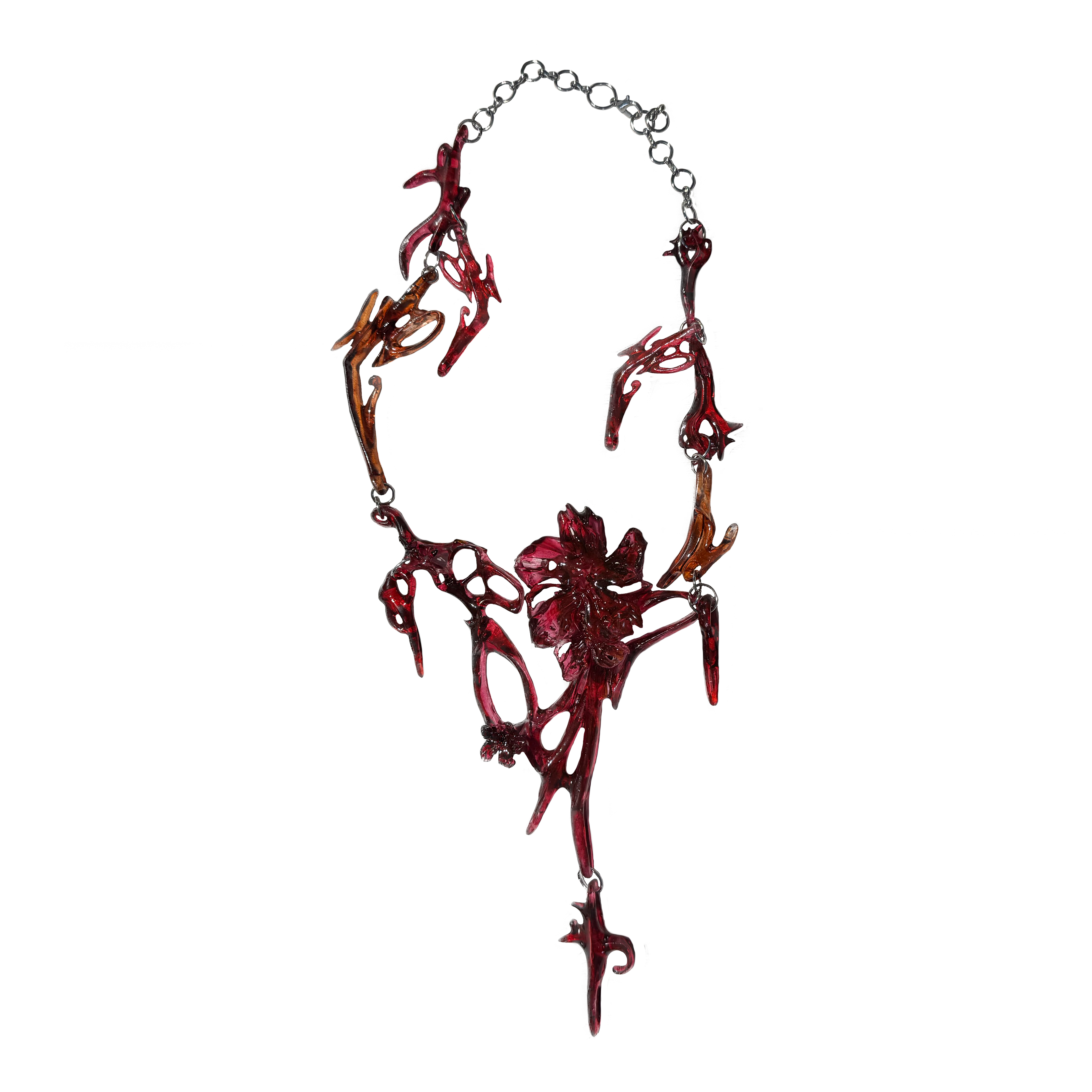 Artistic necklace with red and brown abstract design on a white background