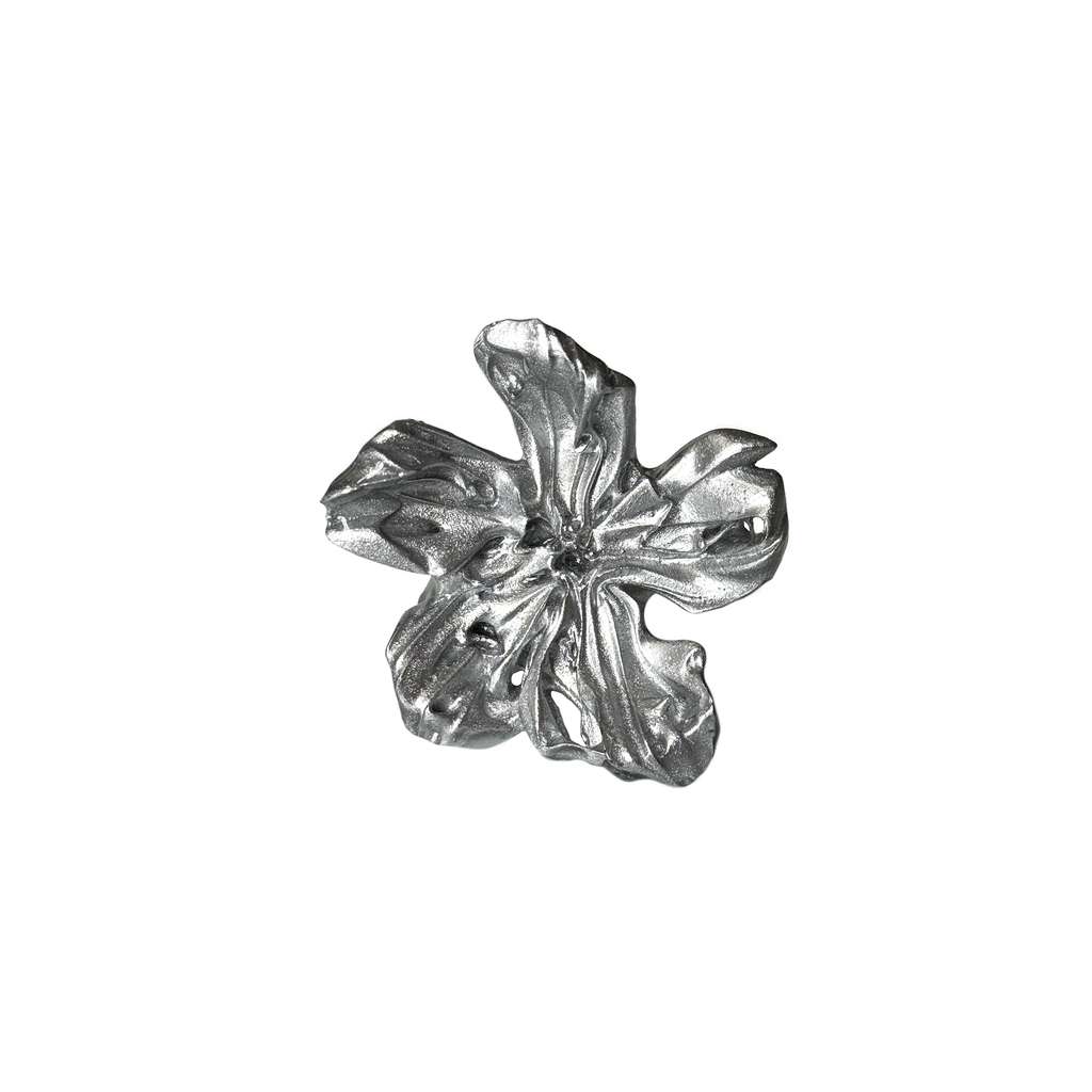 Silver flower-shaped ring on a white background