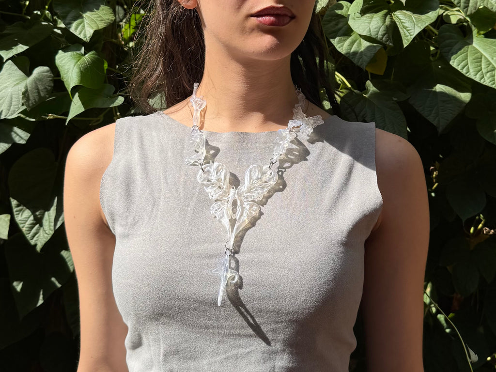 Woman wearing a opalescent abstract 3D printed necklace