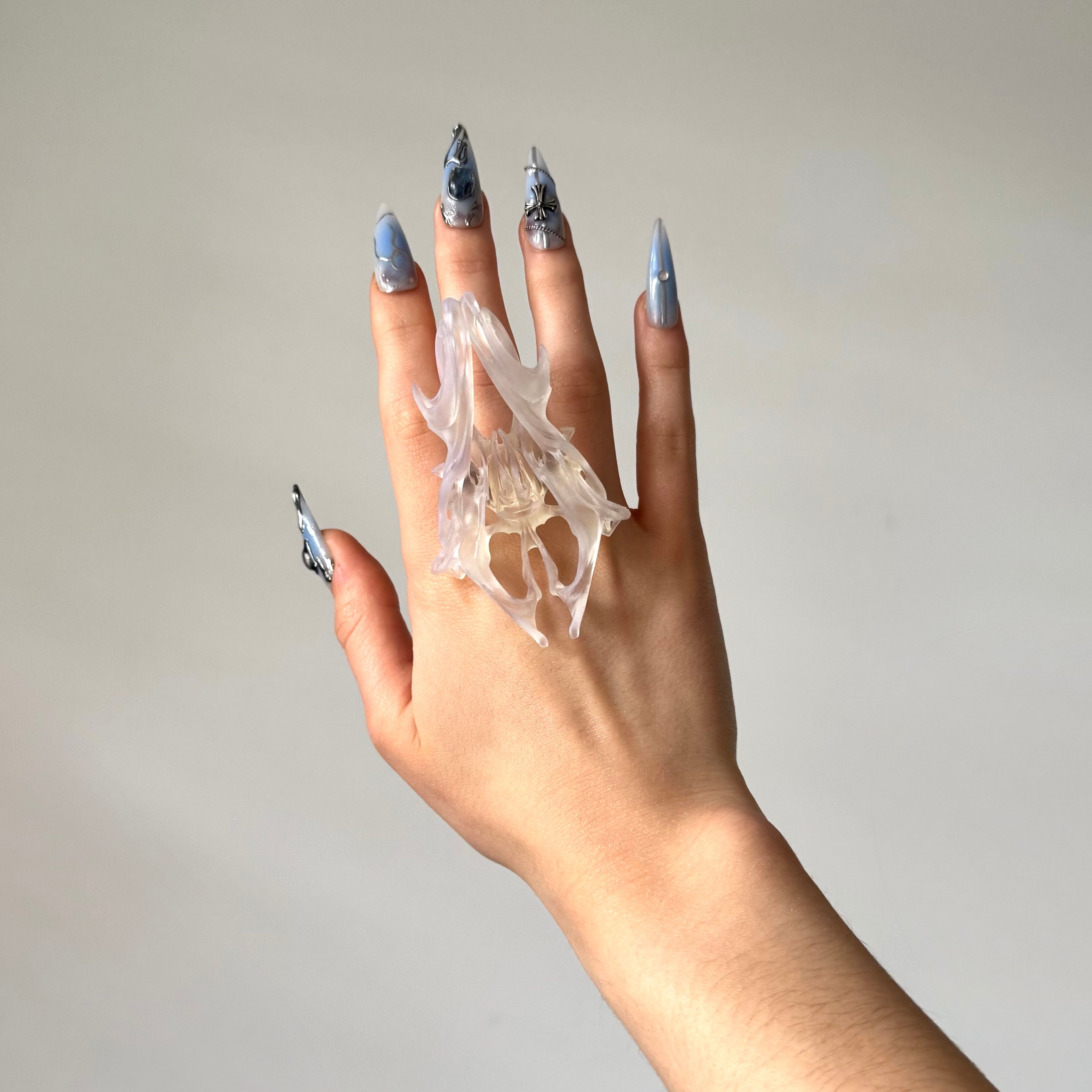 Hand wearing a statement clear chunky 3D printed ring.