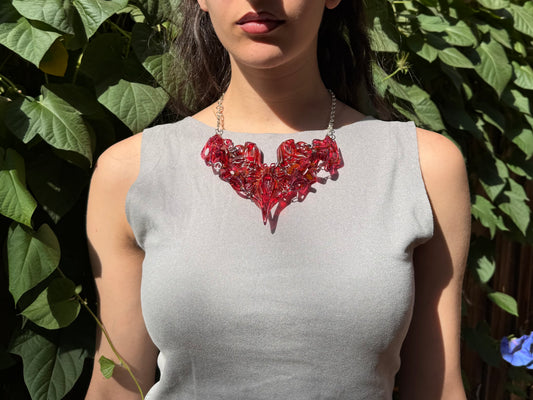 Woman wearing a red 3D printed resin statement necklace