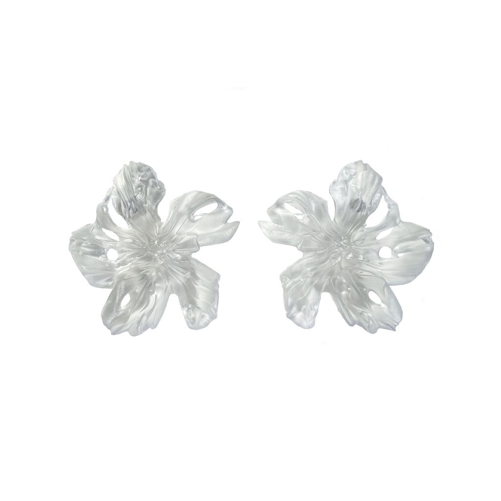 Pair of clear flower-shaped 3D printed resin earrings on a white background