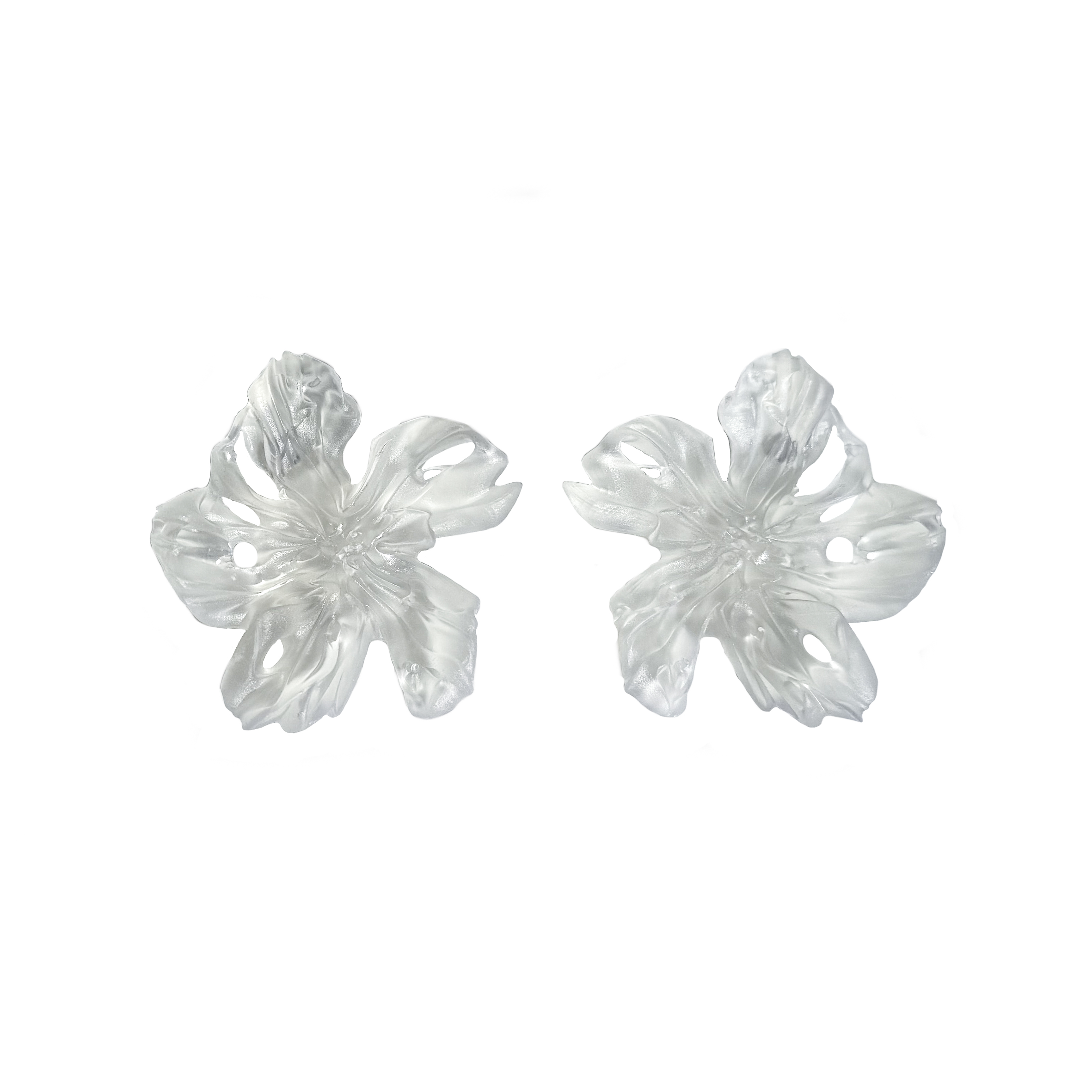 Pair of clear flower-shaped 3D printed resin earrings on a white background