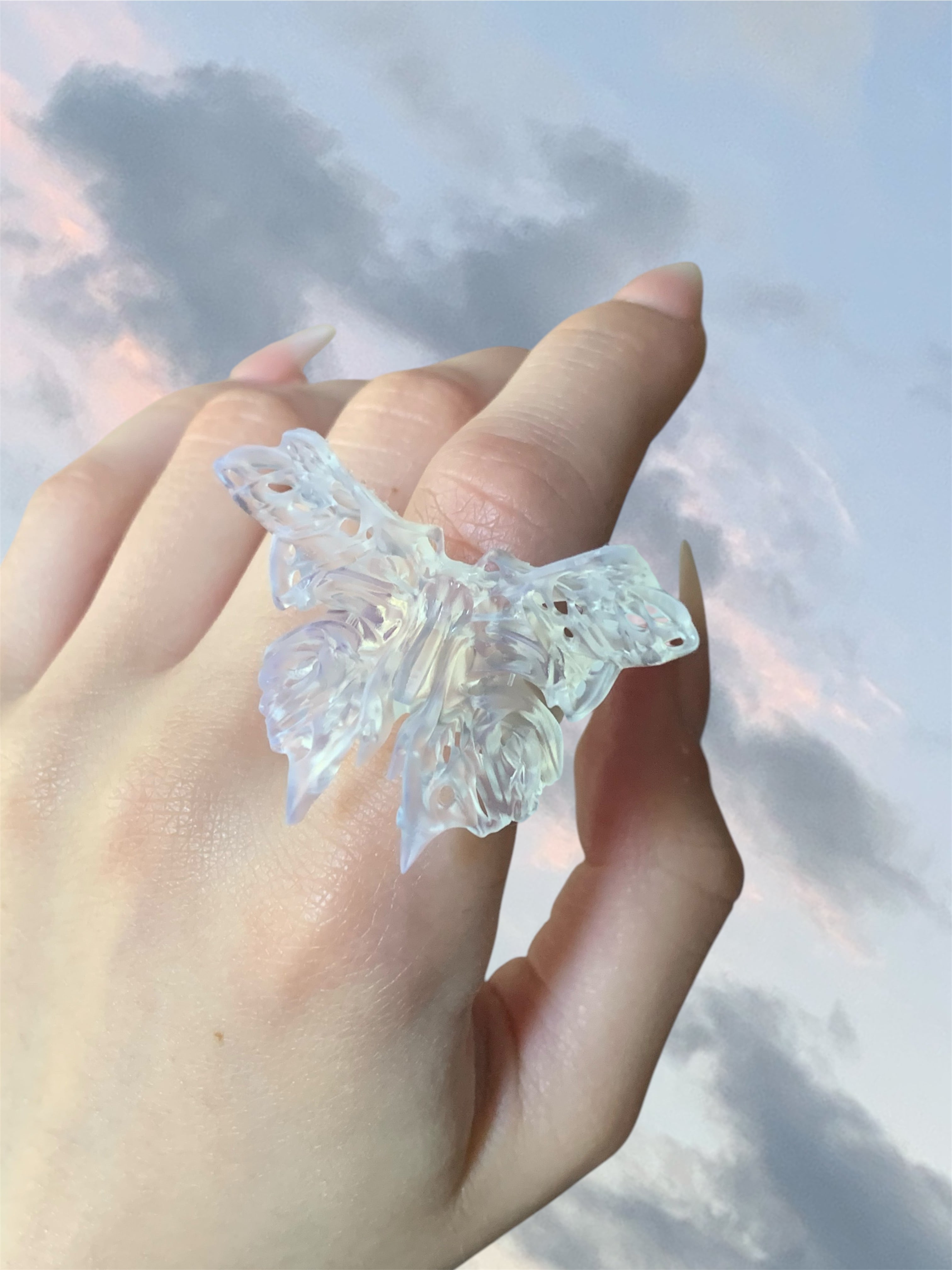 Hand wearing a statement 3D printed butterfly ring