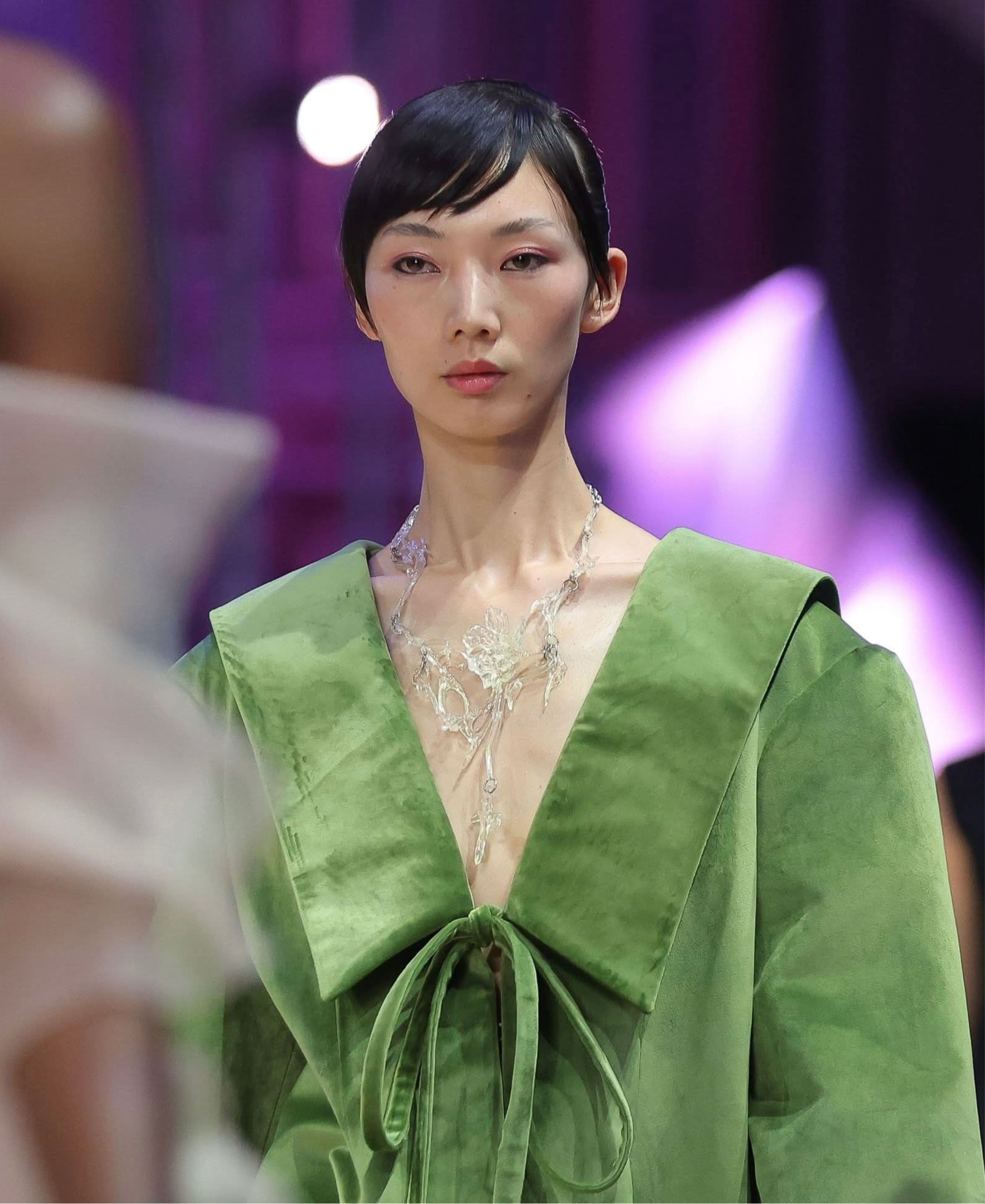 Model wearing a statement clear gloss floral necklace