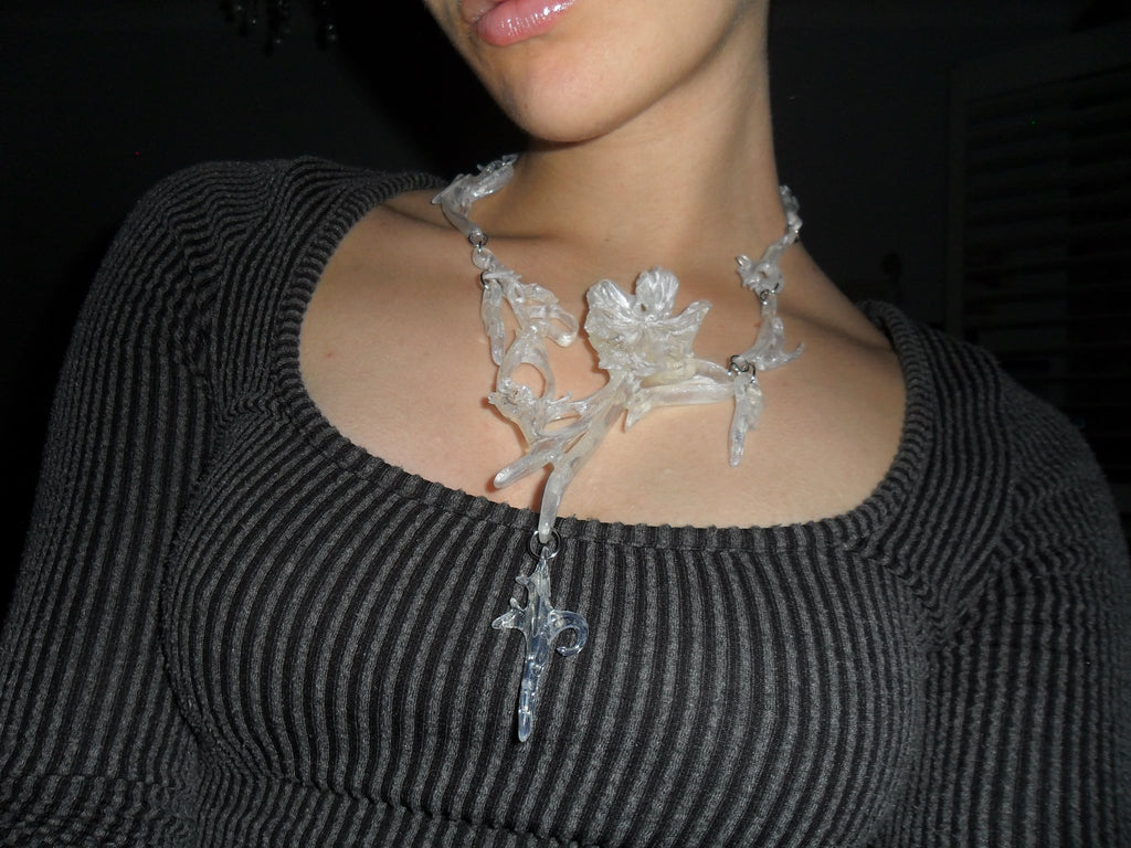 Opalescent 3D printed necklace with a unique floral statement abstract design worn.