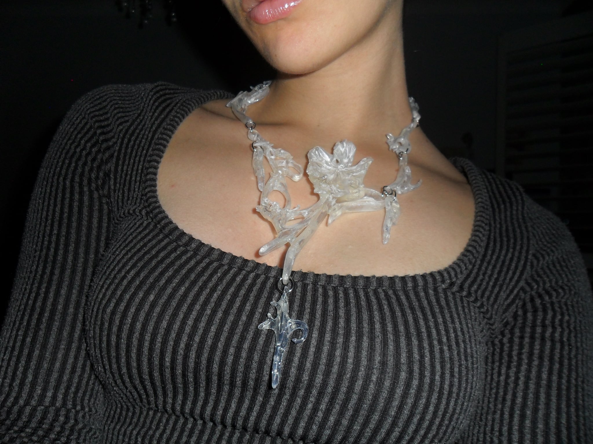 Opalescent 3D printed necklace with a unique floral statement abstract design worn.