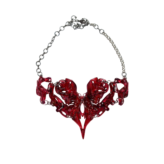 Red abstract heart necklace on a white background