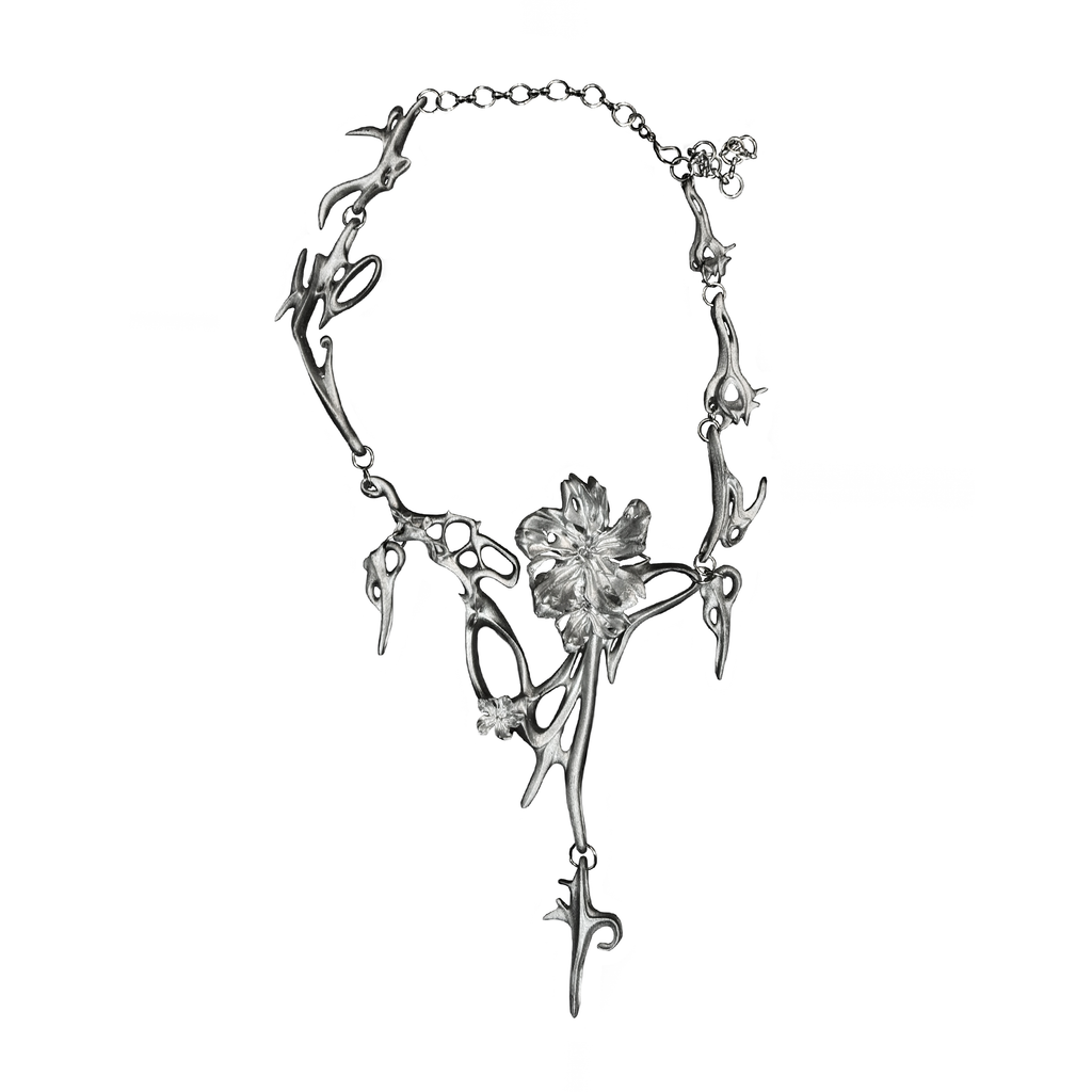 Silver necklace with floral design on a white background