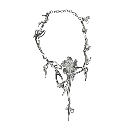 Silver necklace with floral design on a white background