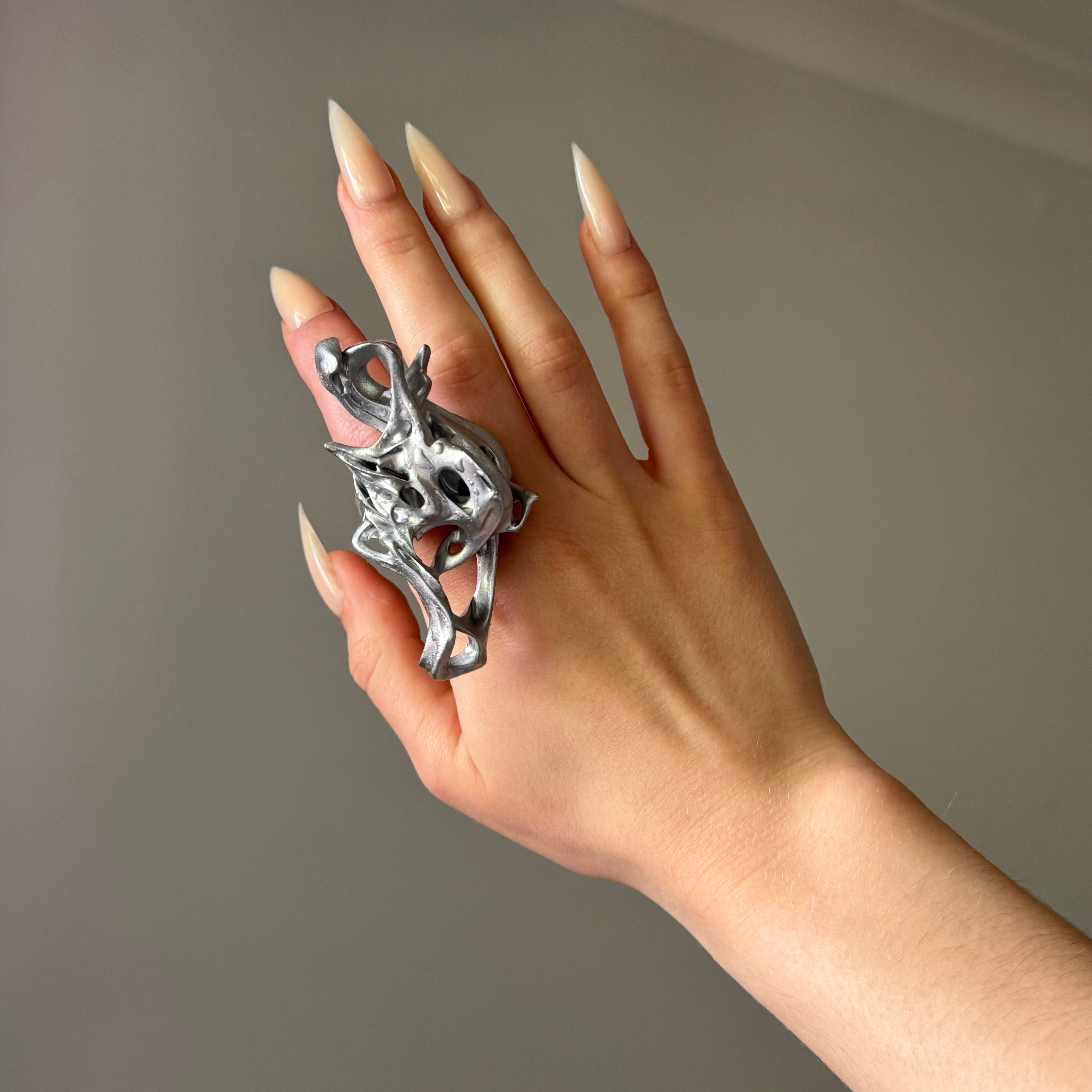 Hand wearing a statement abstract chunky silver 3D printed ring