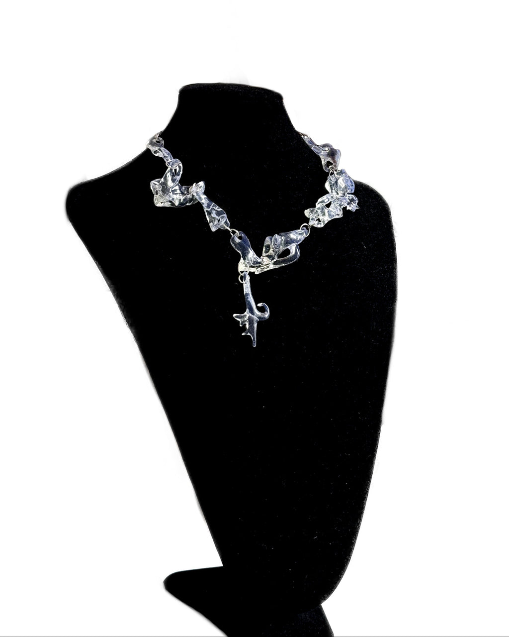 clear chunky necklace on a black mannequin bust against a white background