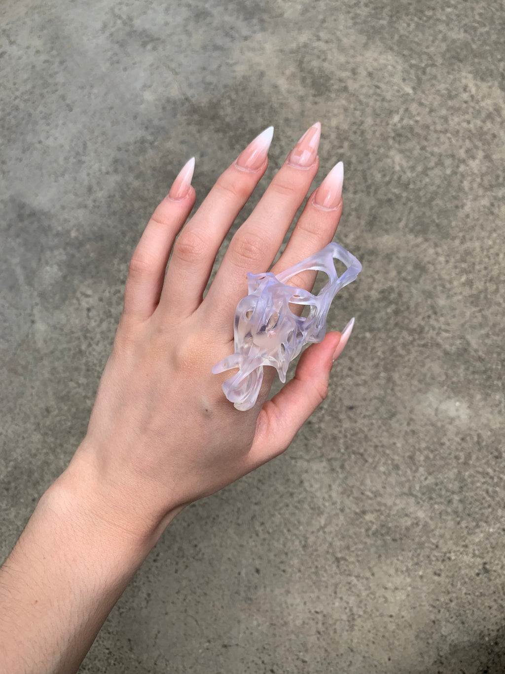 Hand wearing a clear resin statement 3D printed ring