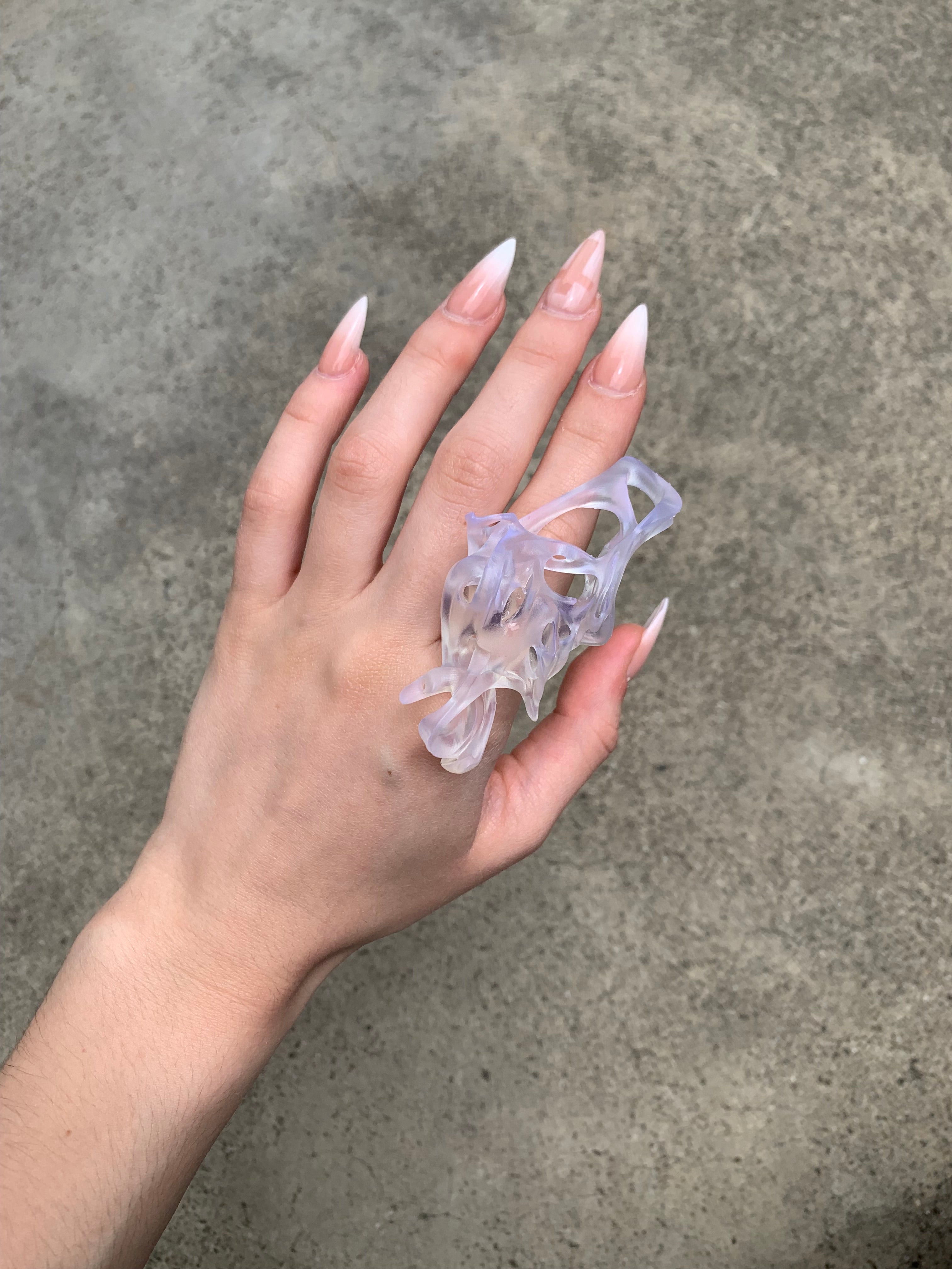 Hand wearing a clear resin statement 3D printed ring