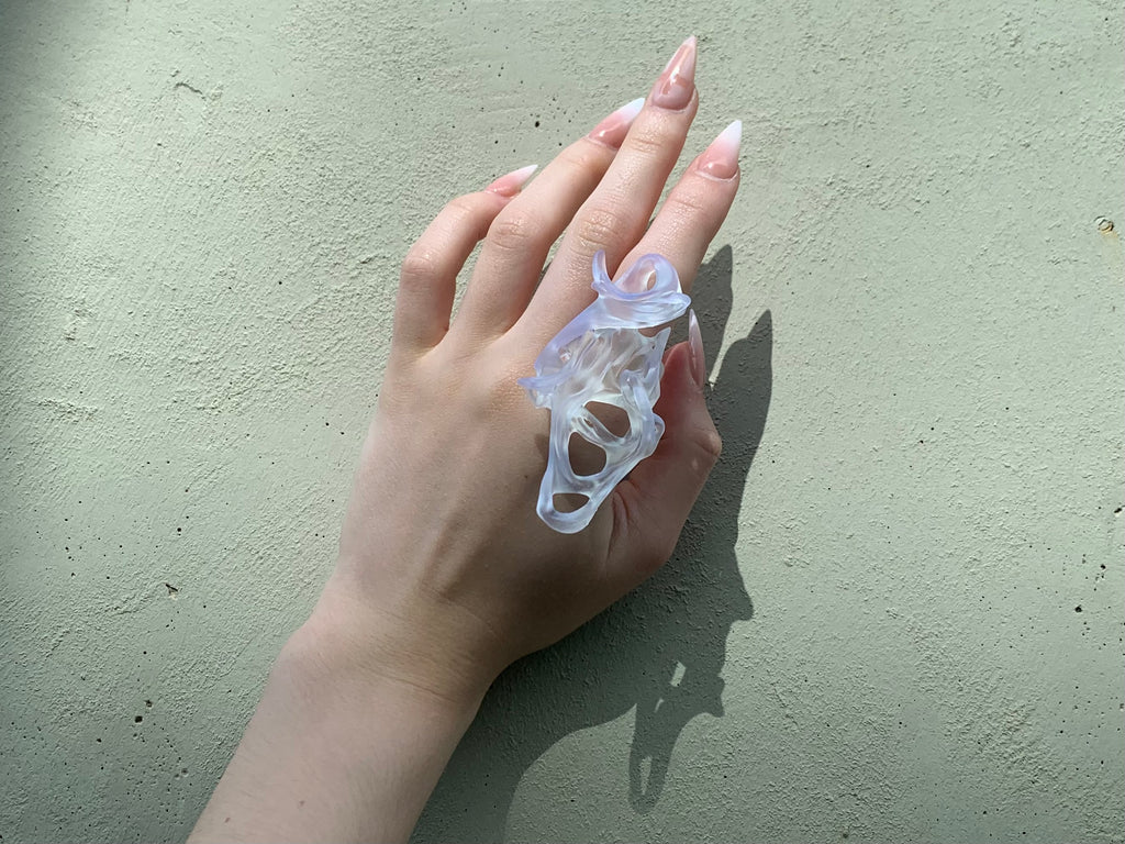 Hand wearing a clear resin statement 3D printed ring