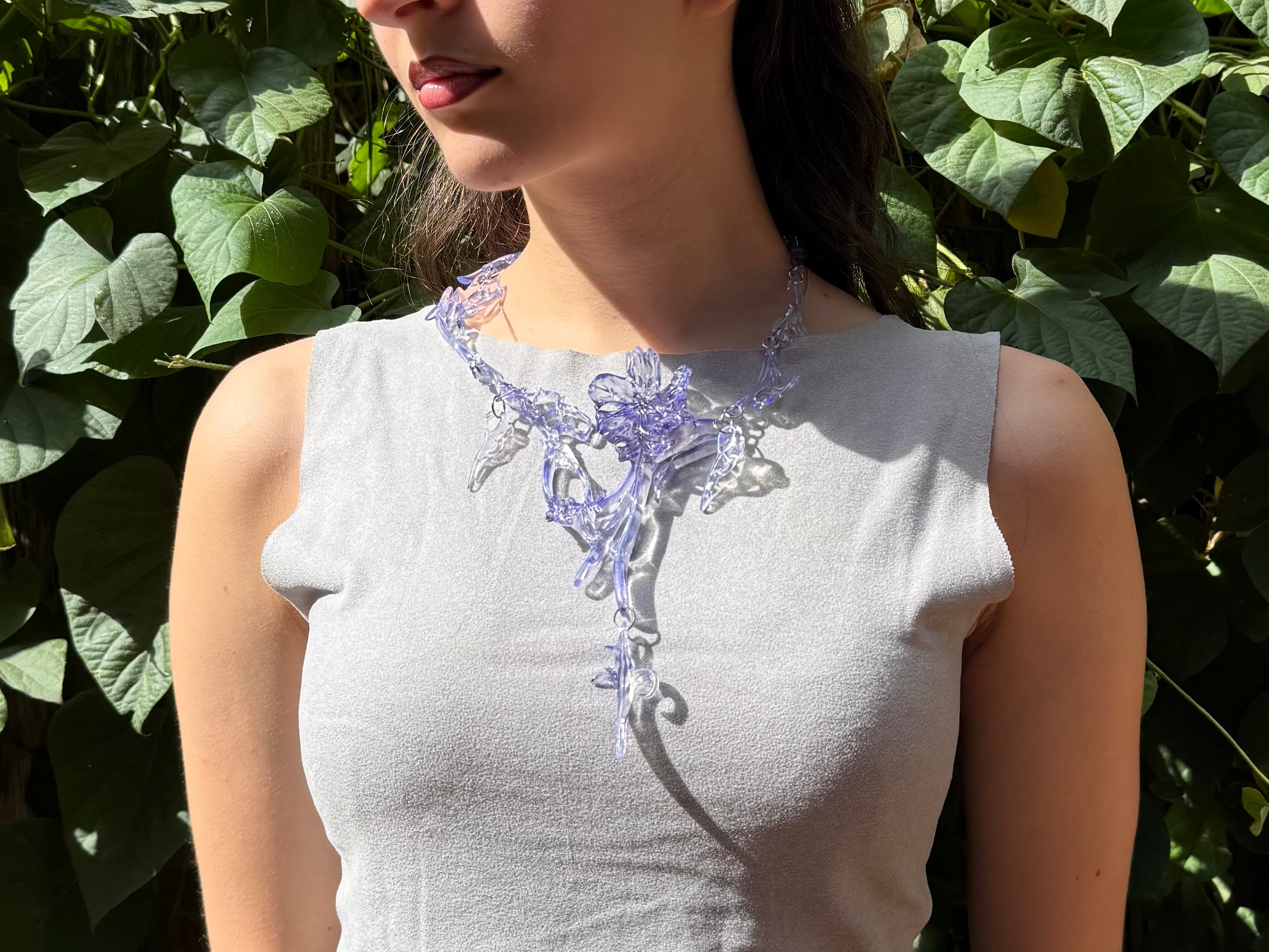 Woman wearing a statement abstract purple necklace