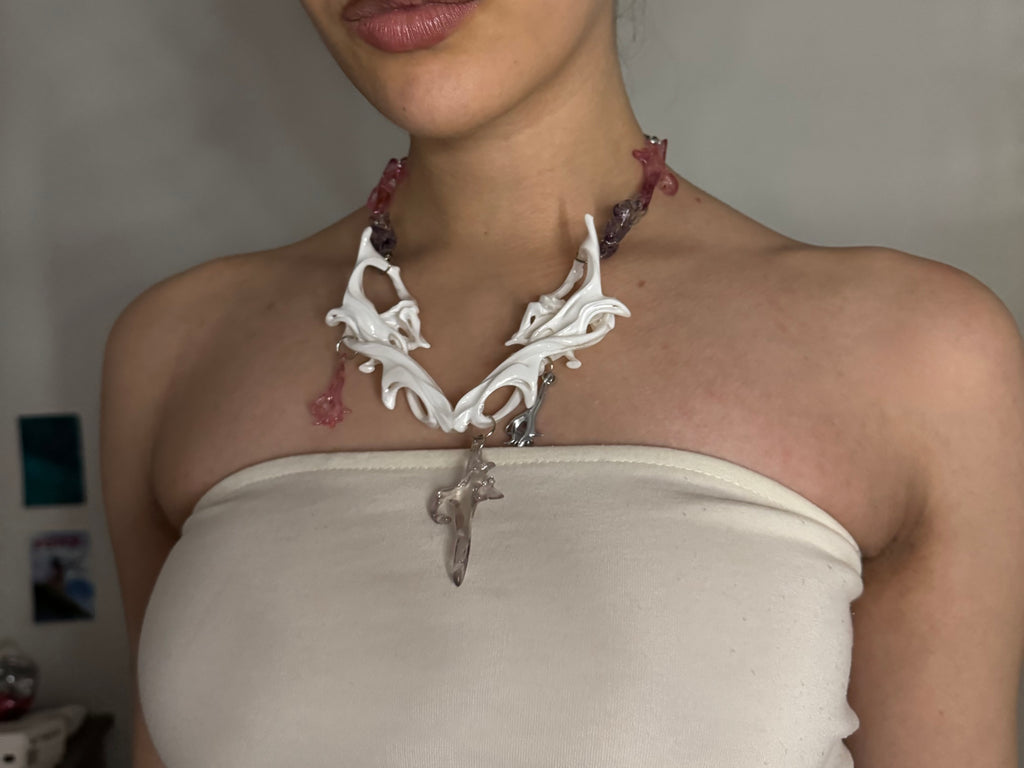 Person wearing a unique necklace with intricate design