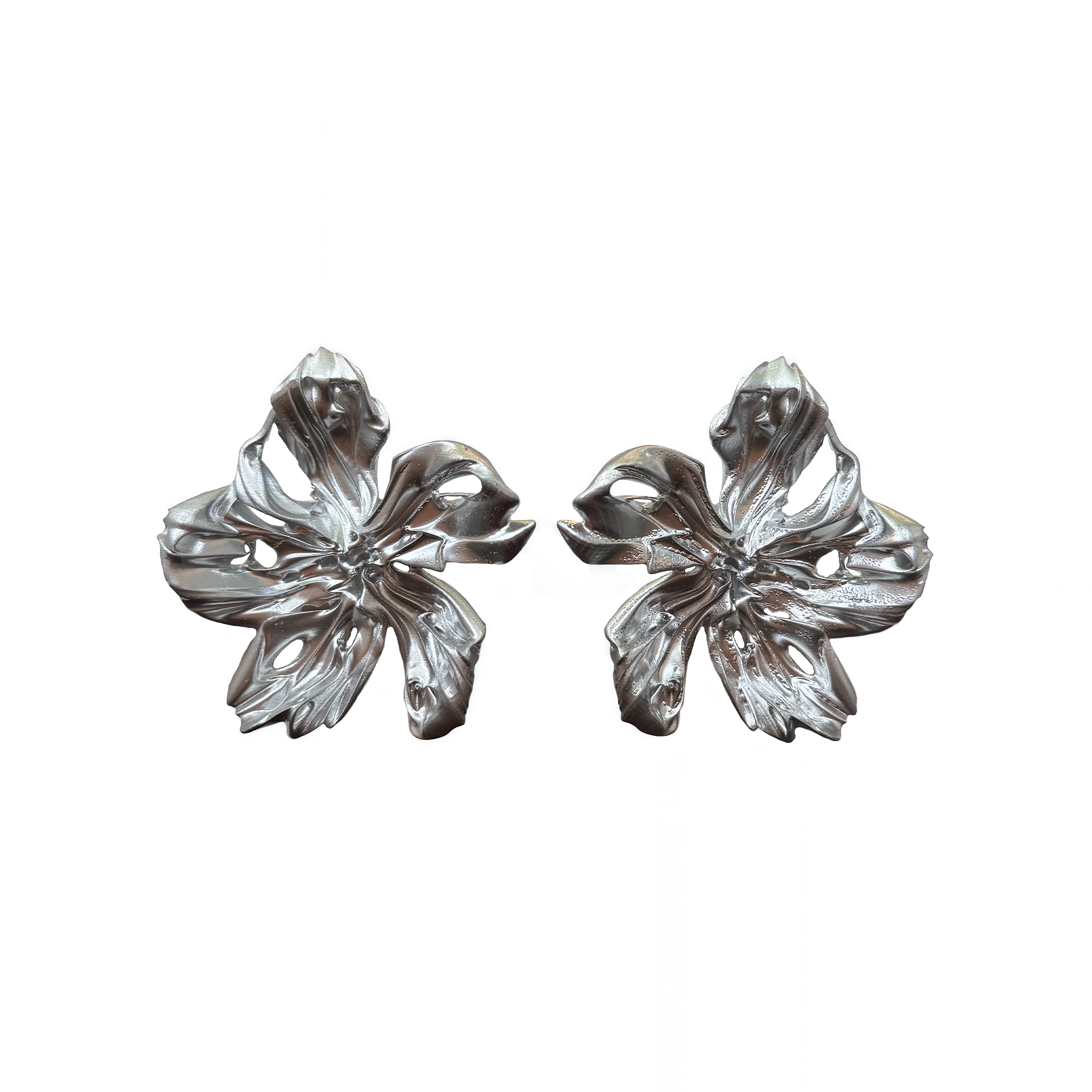 Pair of silver floral statement earrings on a white background