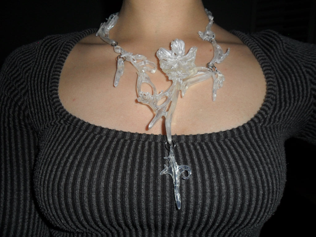 Opalescent necklace with a unique floral statement abstract design worn.