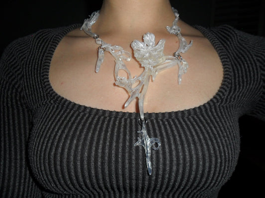 Opalescent necklace with a unique floral statement abstract design worn.